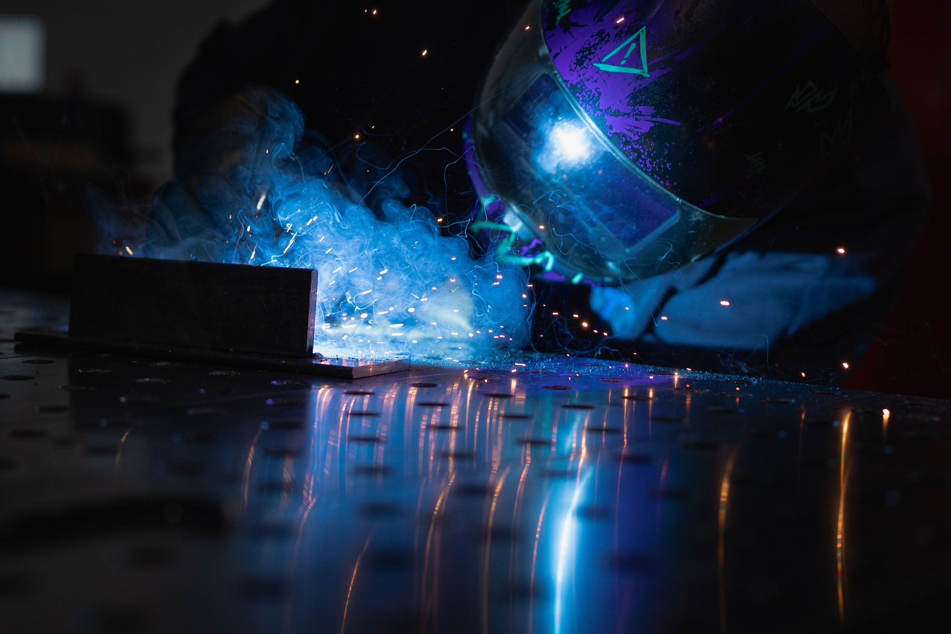 Precision welding sparks on a steel fixture